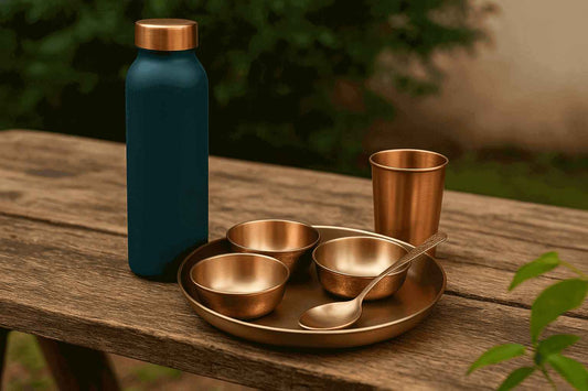 copper water bottle with copper utensils on wooden table 