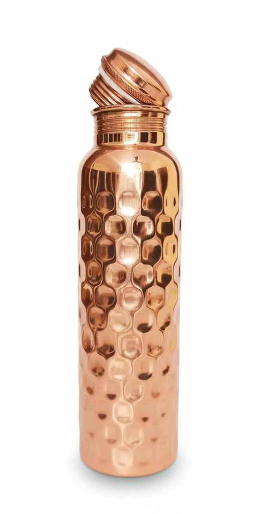 Copper water bottle with a textured surface on a white background
