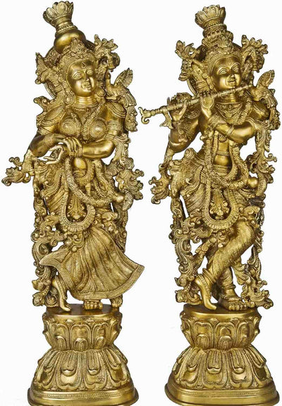 Two ornate Hindu god brass statues on a white background